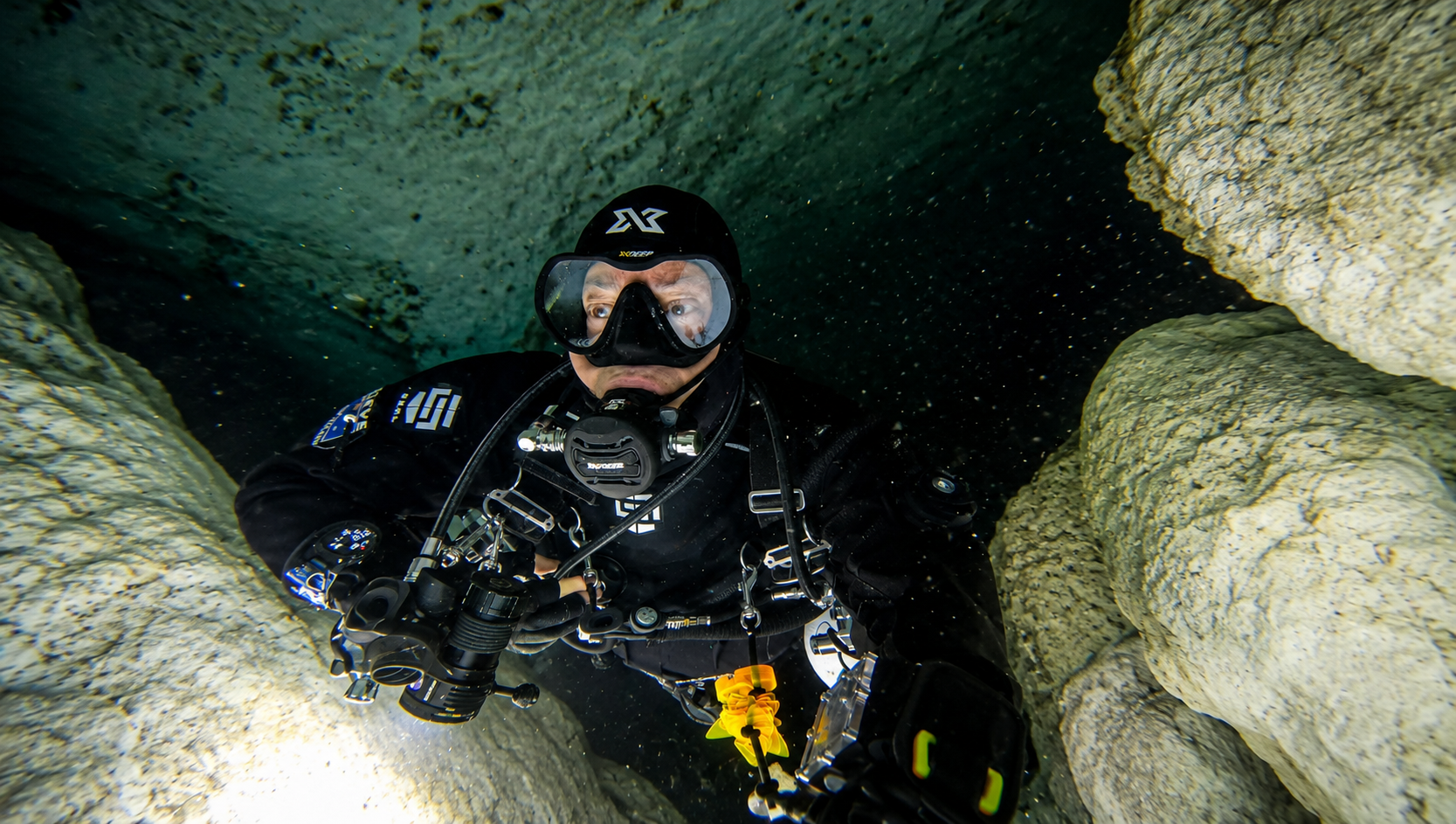 Steve Davis diving in his SEAL drysuit inside a cave