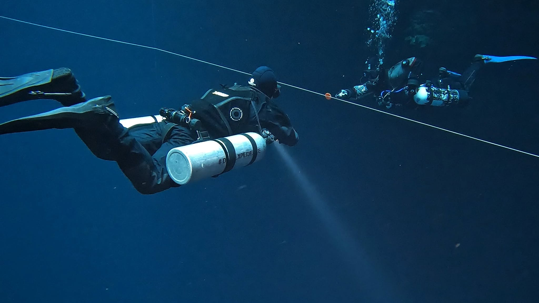 Two sidemount divers practising together underwater